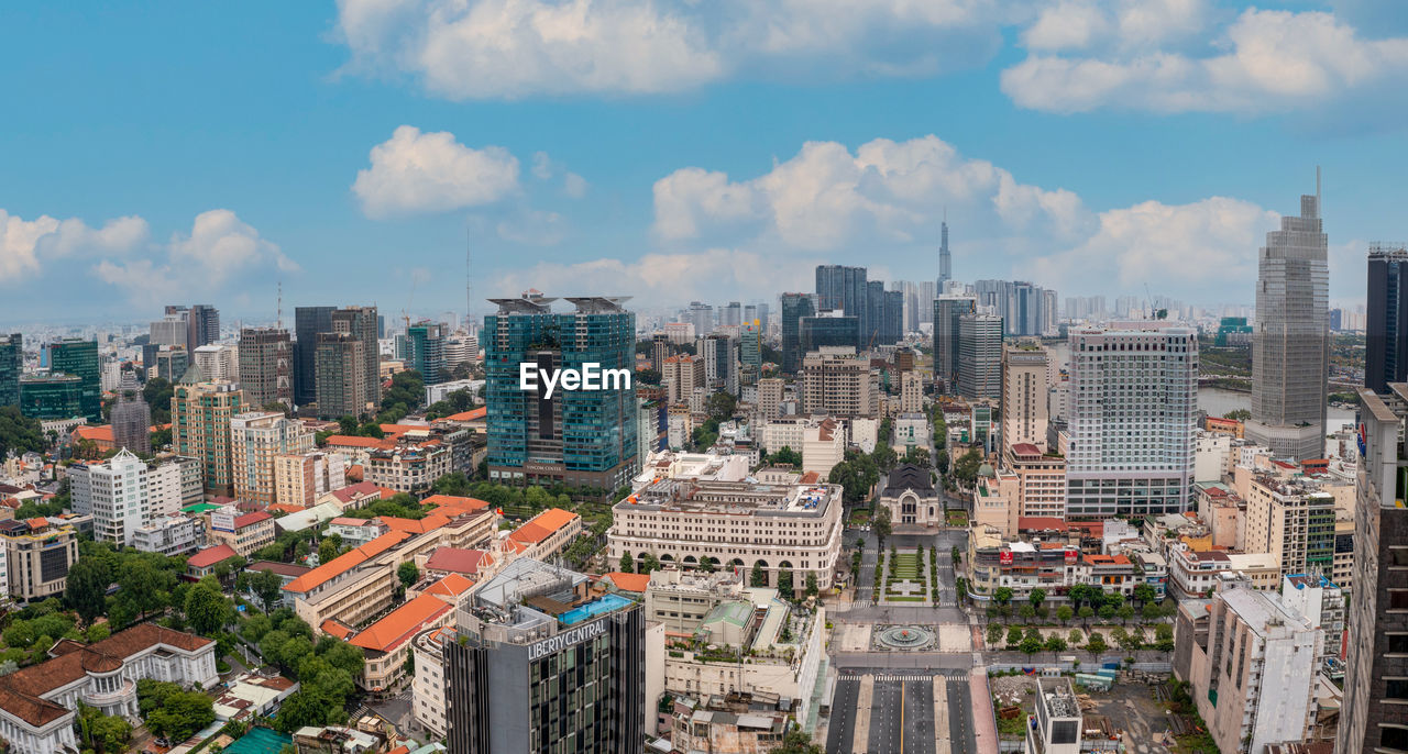 Aerial view of buildings in city against sky