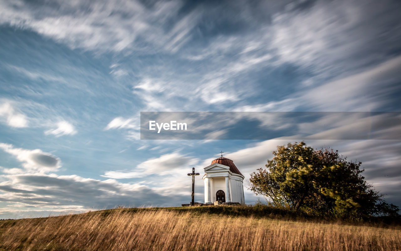 Chapel on field against sky