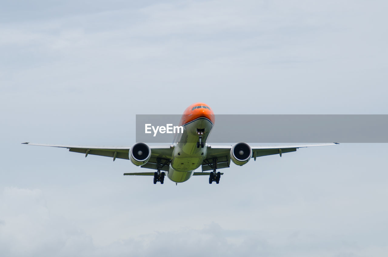 Low angle view of airplane flying against sky