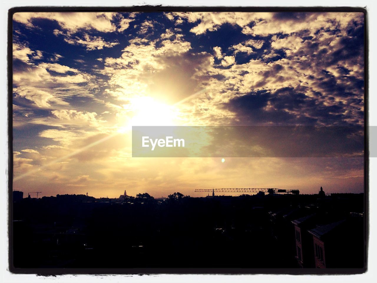 SILHOUETTE OF BUILT STRUCTURE AGAINST CLOUDY SKY