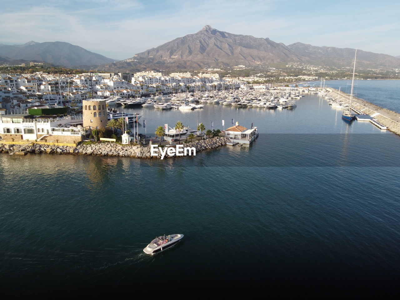 HIGH ANGLE VIEW OF SAILBOAT IN SEA AGAINST MOUNTAIN