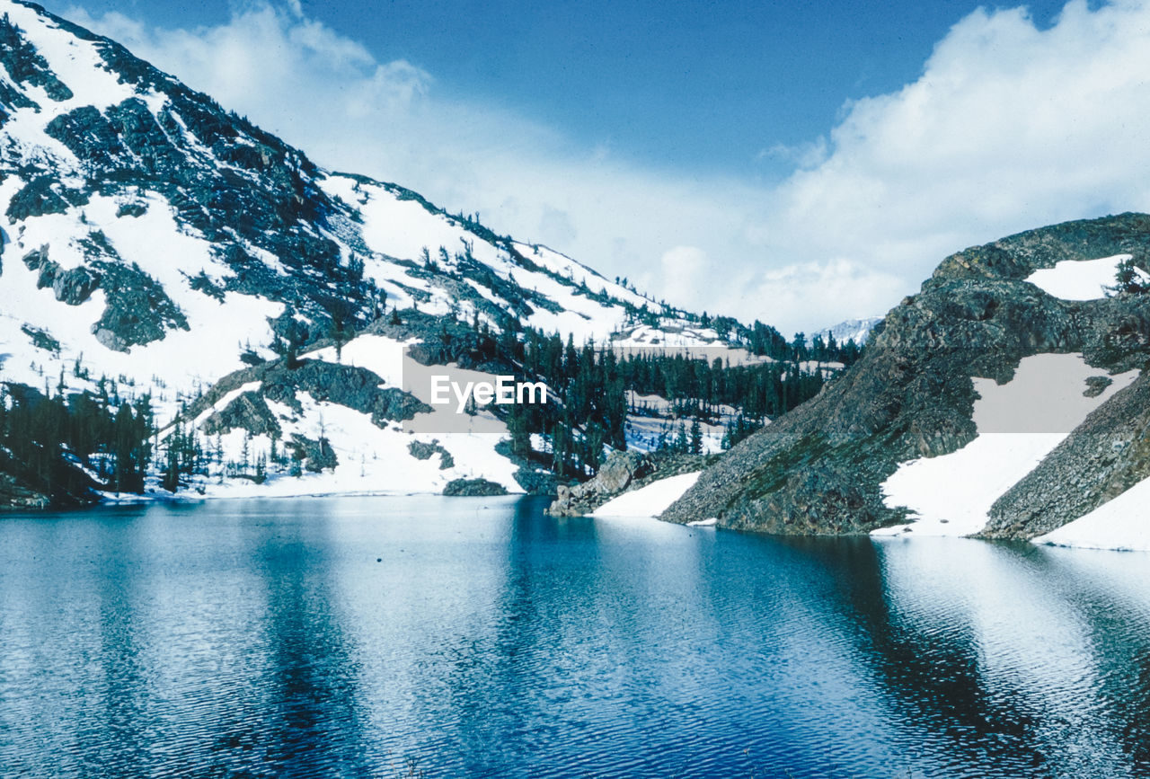 scenic view of snowcapped mountains against blue sky