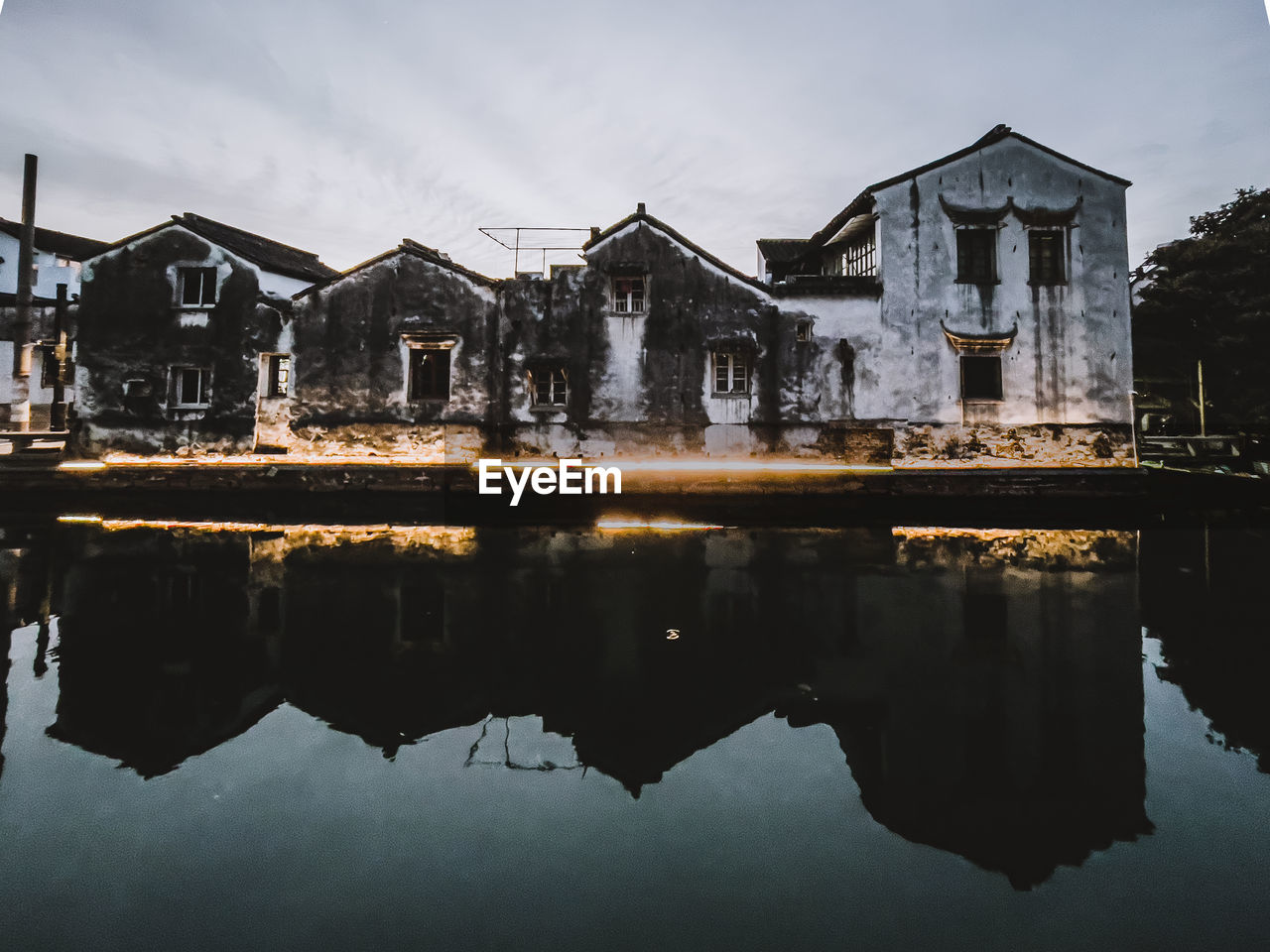 Reflection of buildings on lake against sky