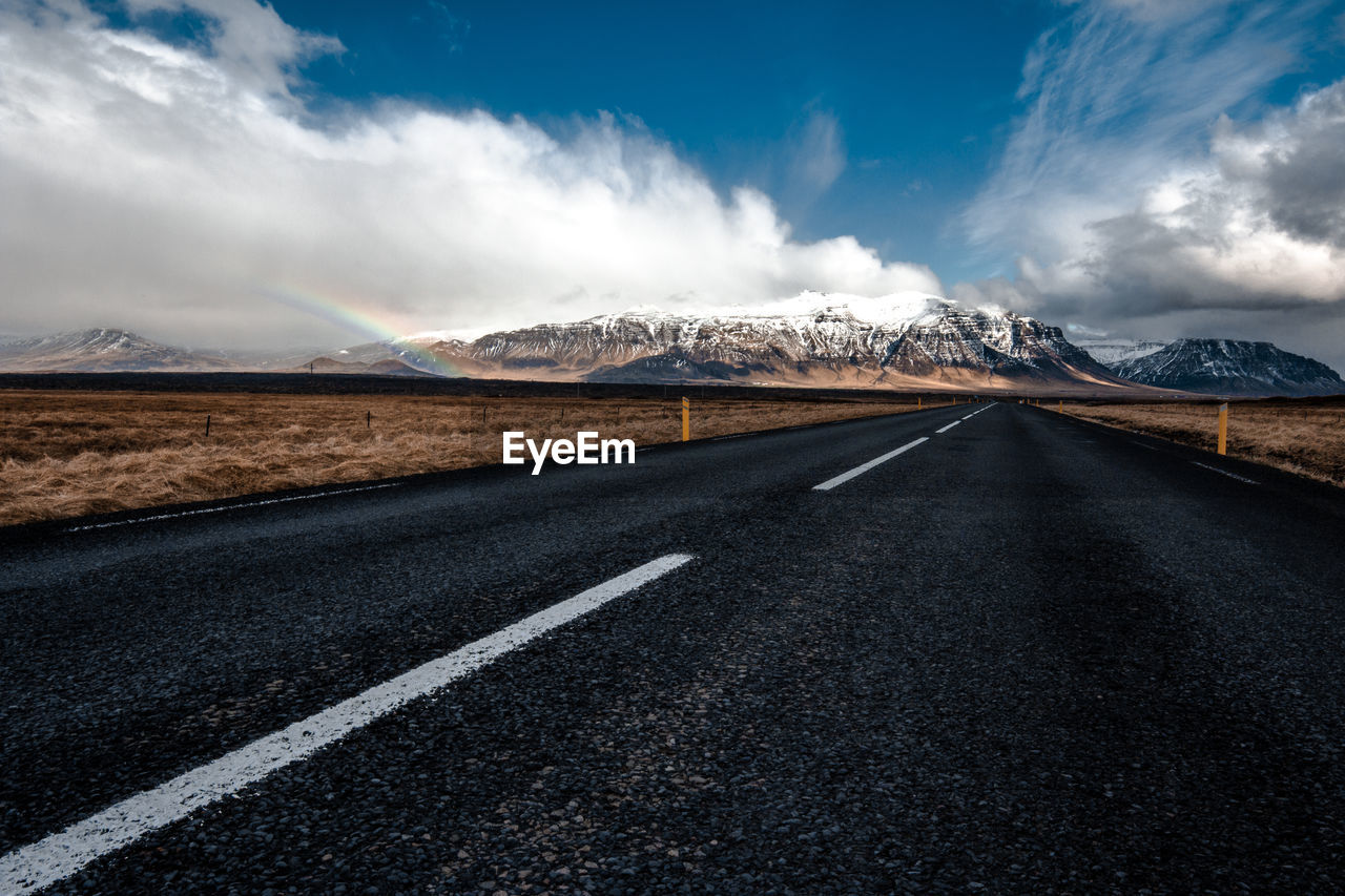 Empty road leading towards mountains