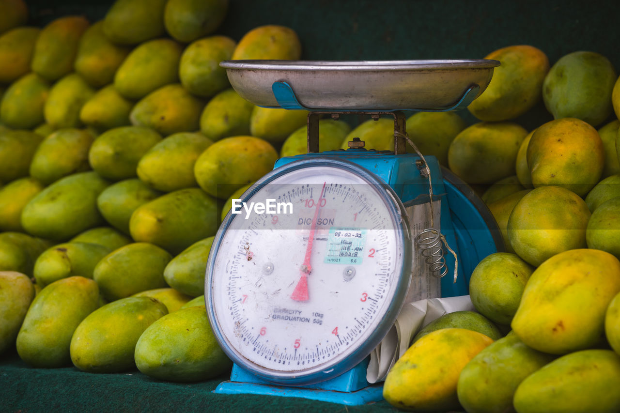 Weight scale at the mango stall.