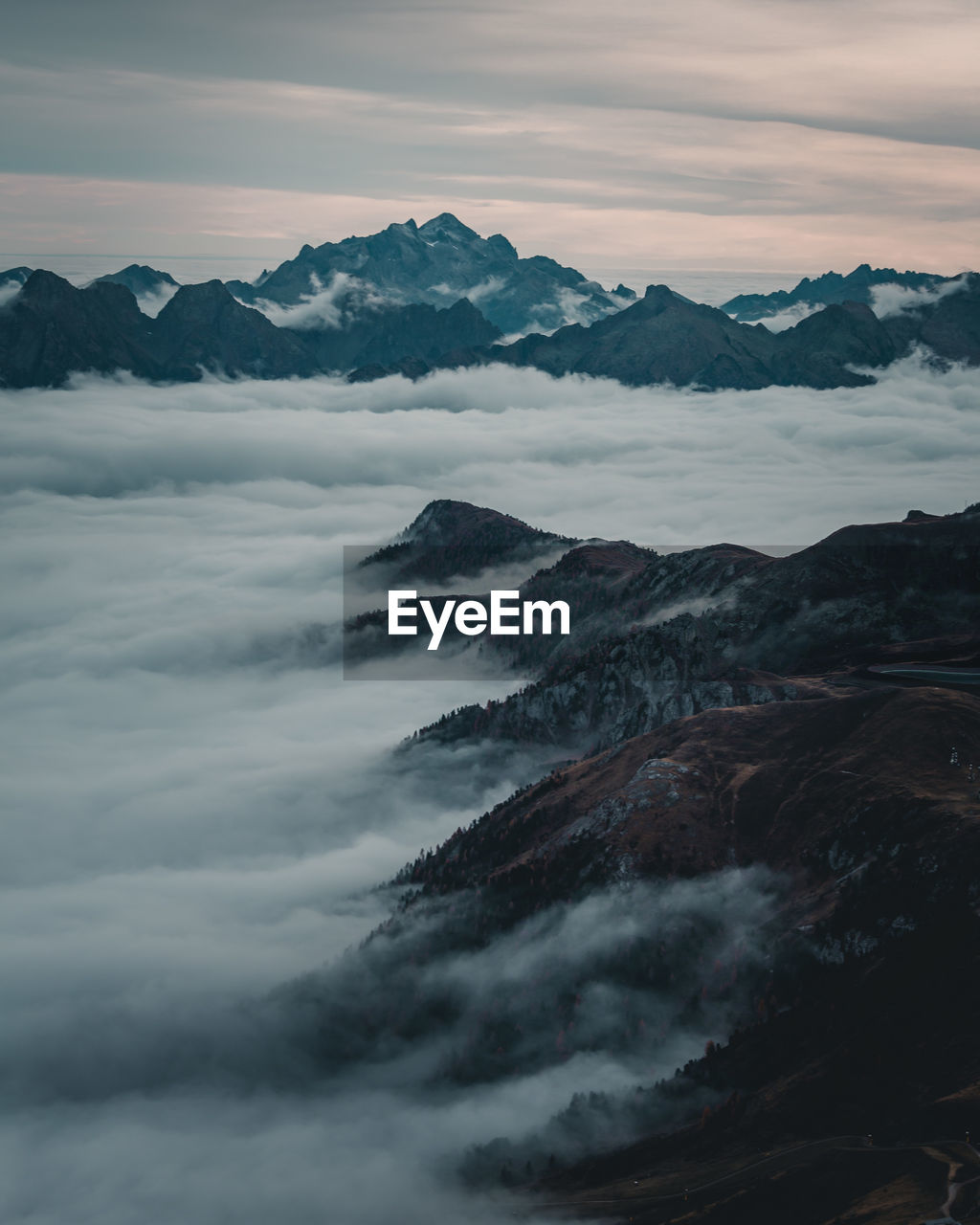 Scenic view of cloudscape against mountains during sunset