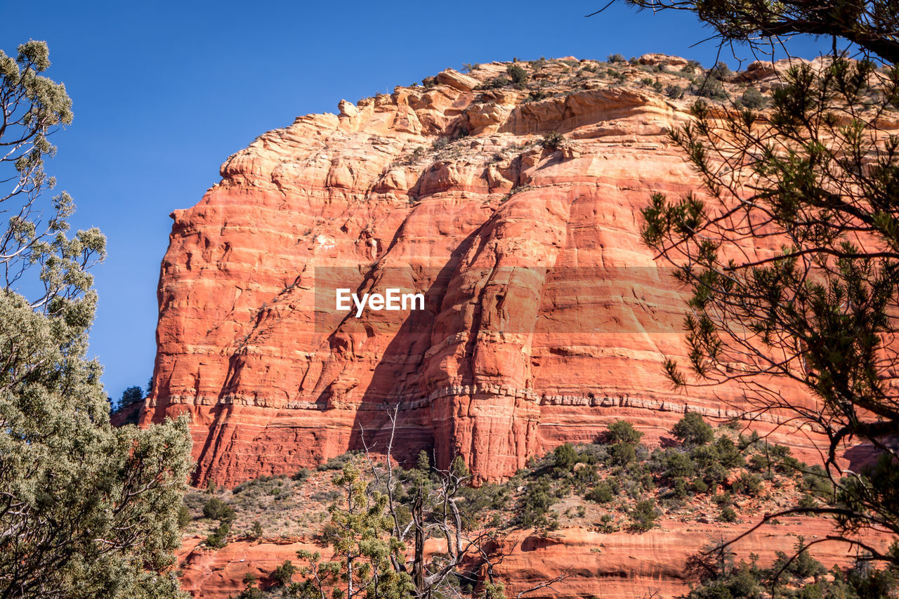 LOW ANGLE VIEW OF ROCK FORMATIONS ON LANDSCAPE