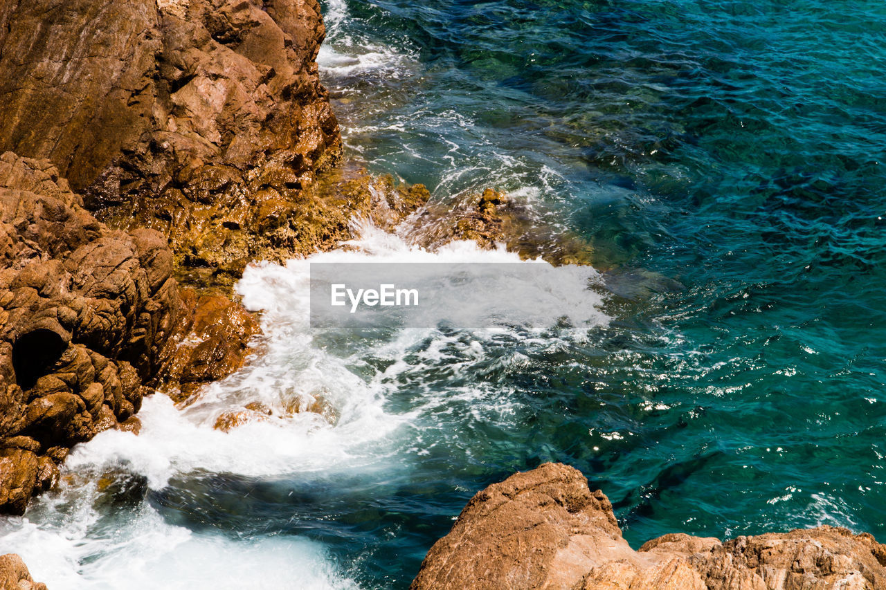 High angle view of rocks in sea