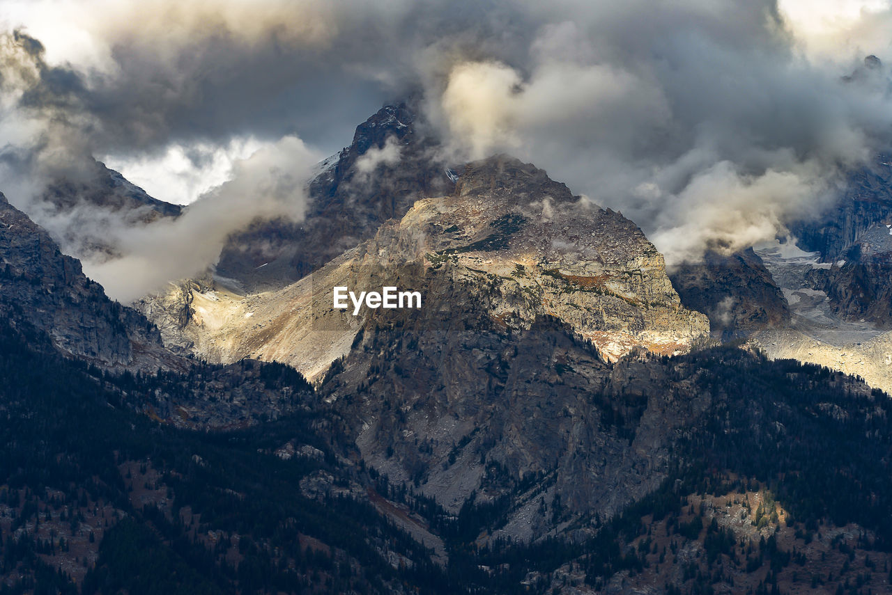 Scenic view of rocky mountains against cloudy sky