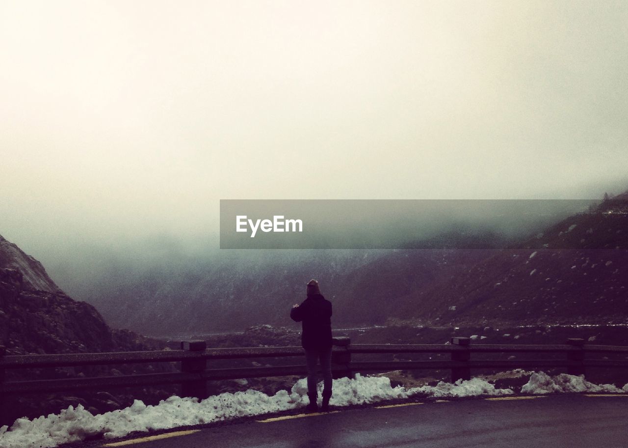 Woman photographing mountains