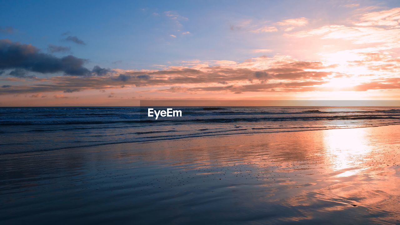 Scenic view of sea against sky at sunset