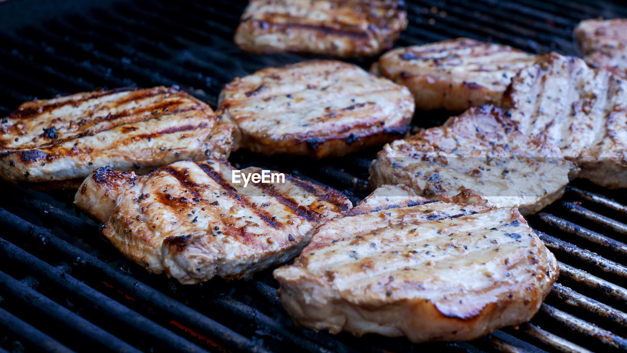 Close-up of grilled meat steak on stainless bbq grill 