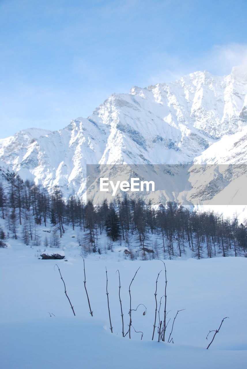 Scenic view of snow covered mountains against sky