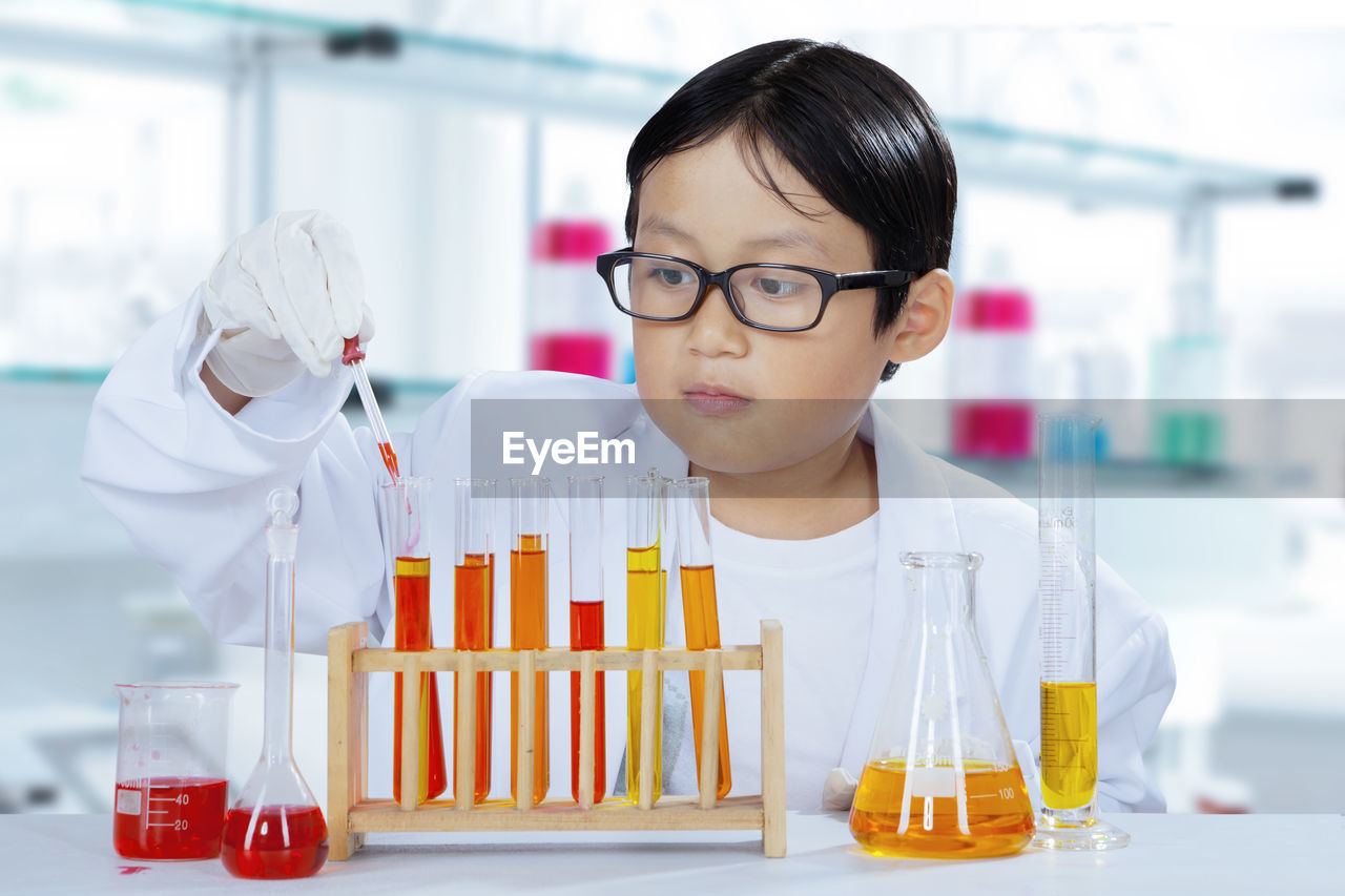 Boy doing experiment in laboratory
