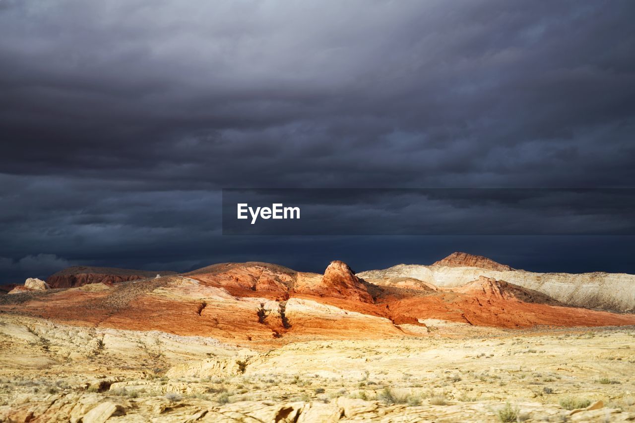 Scenic view of mountain against cloudy sky