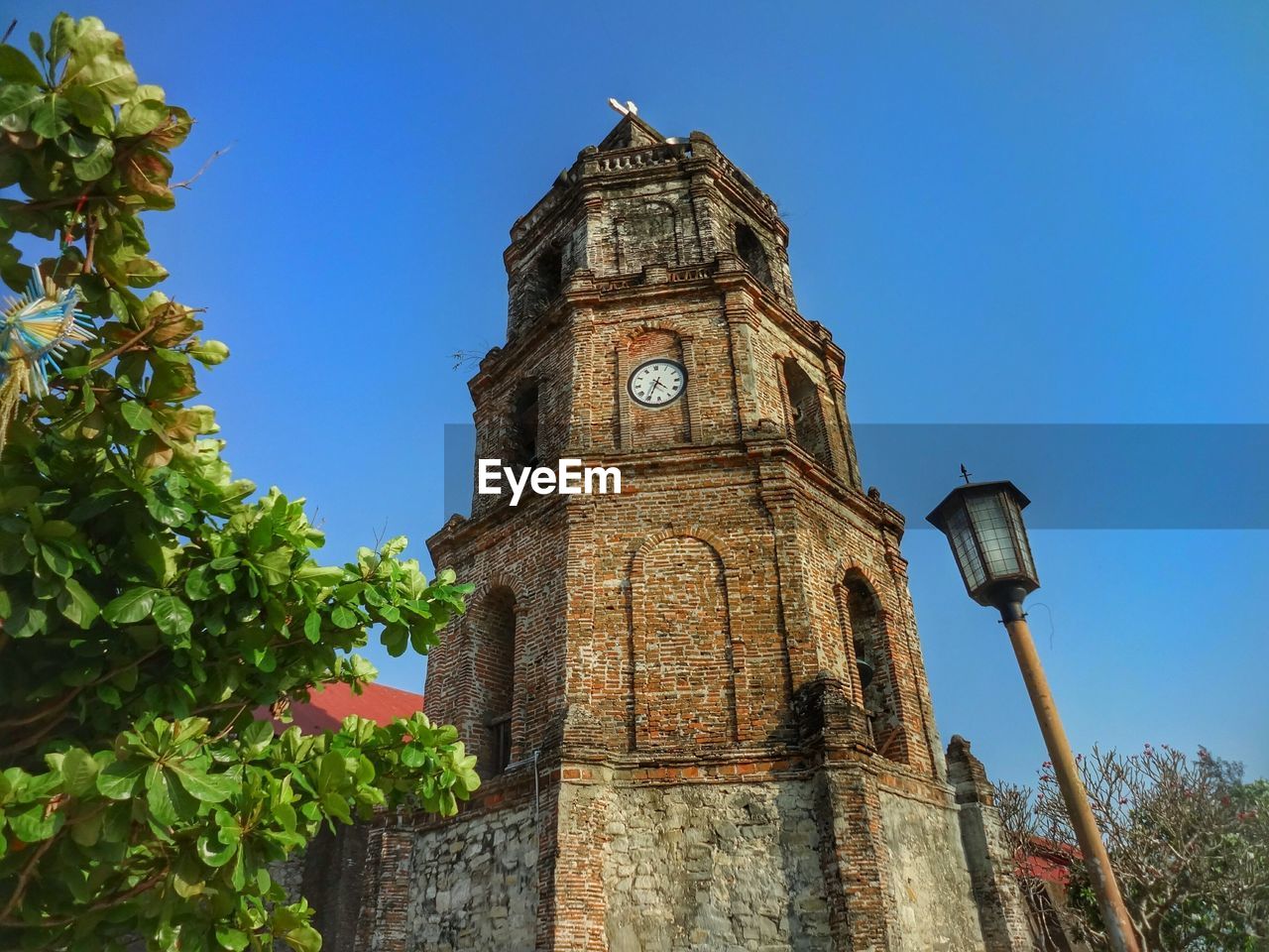 Low angle view of tower against blue sky