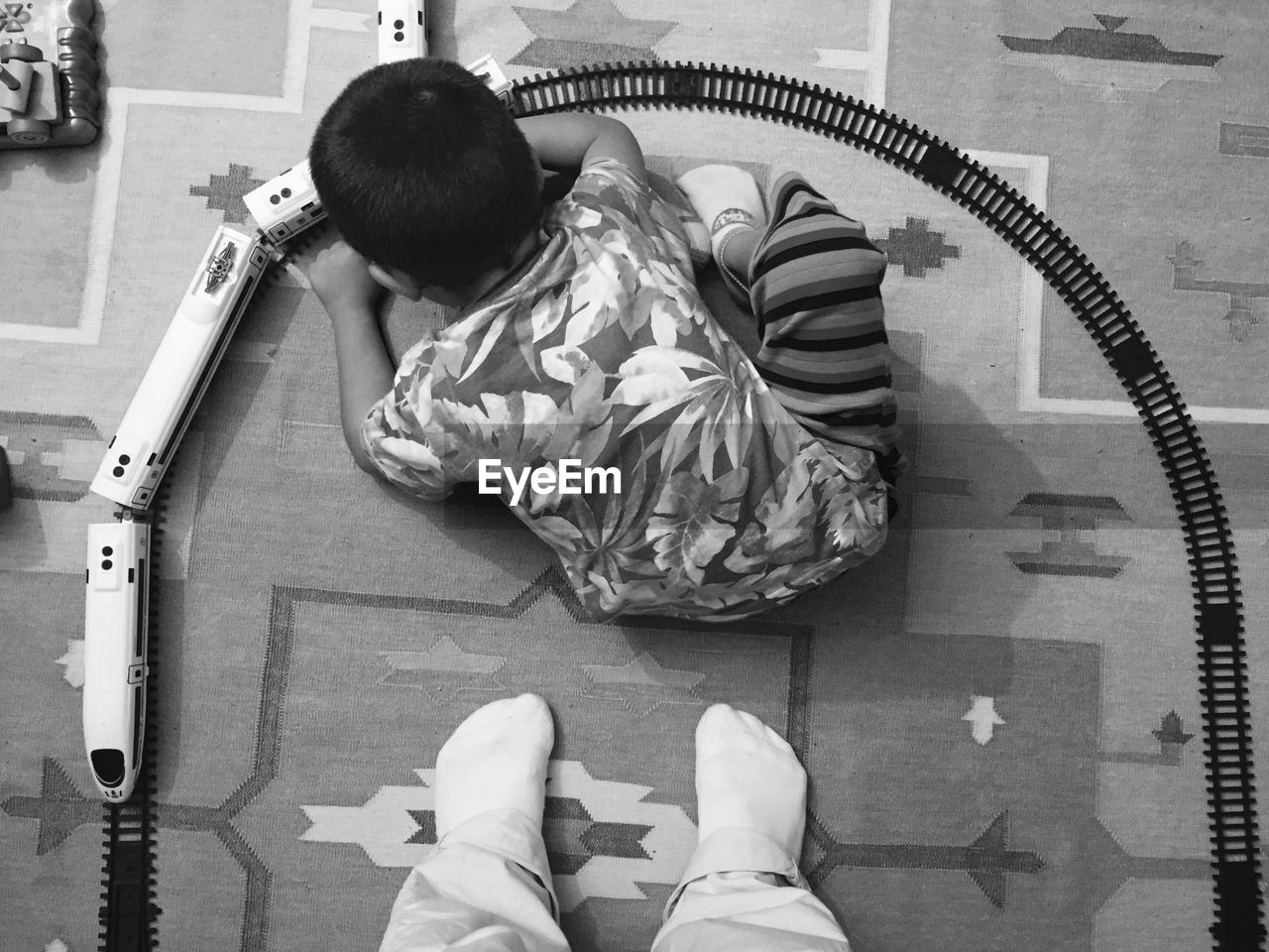 High angle view of boy playing with train set at home