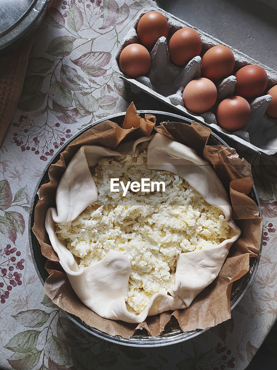 Preparing pie and eggs on table