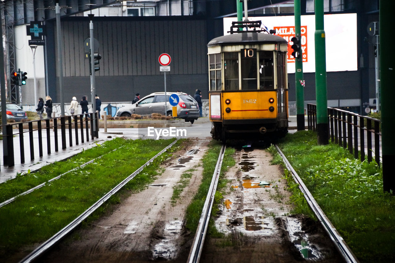 Puddle on railroad tracks against tramway during rainy season