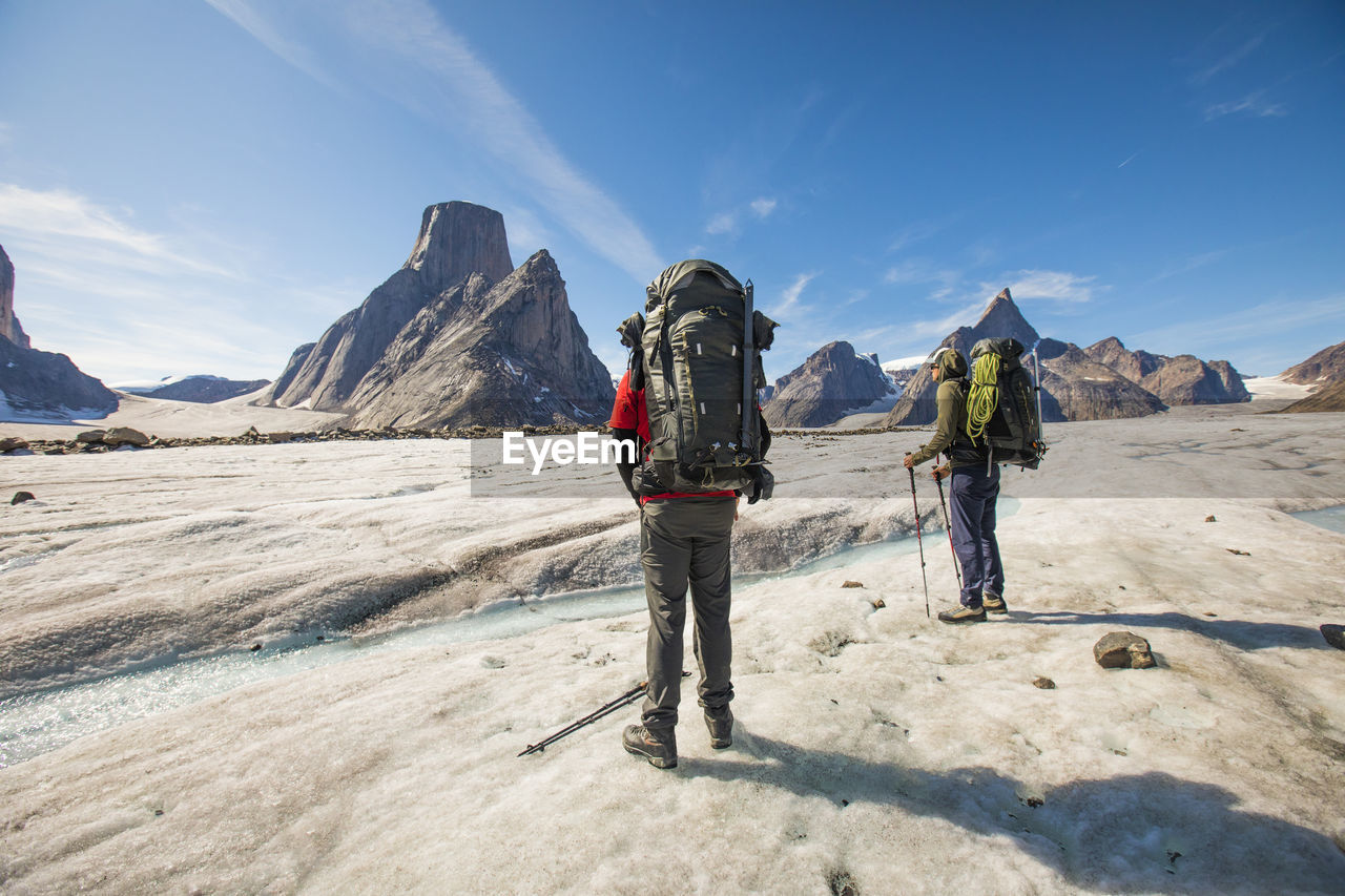 Two backpackers looks up towards their next objective, mount asgard