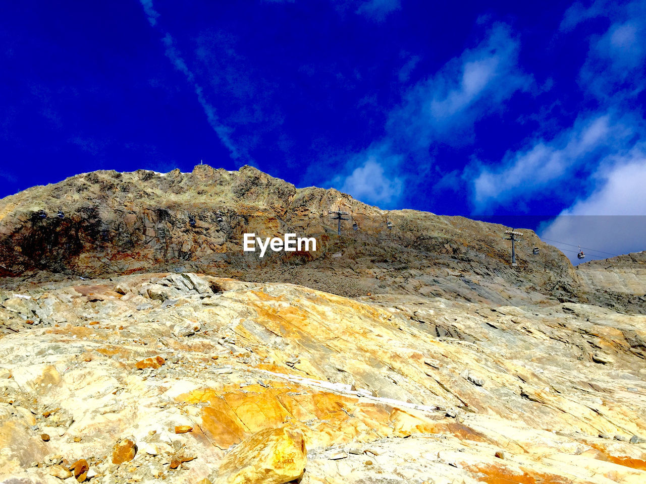 Low angle view of rocky mountain against sky