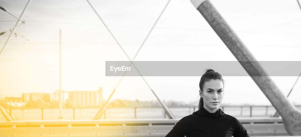 PORTRAIT OF BEAUTIFUL WOMAN STANDING AGAINST SKY