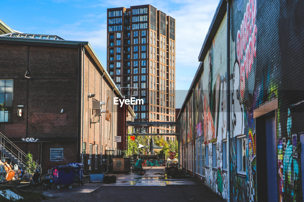 Street amidst buildings in city against sky