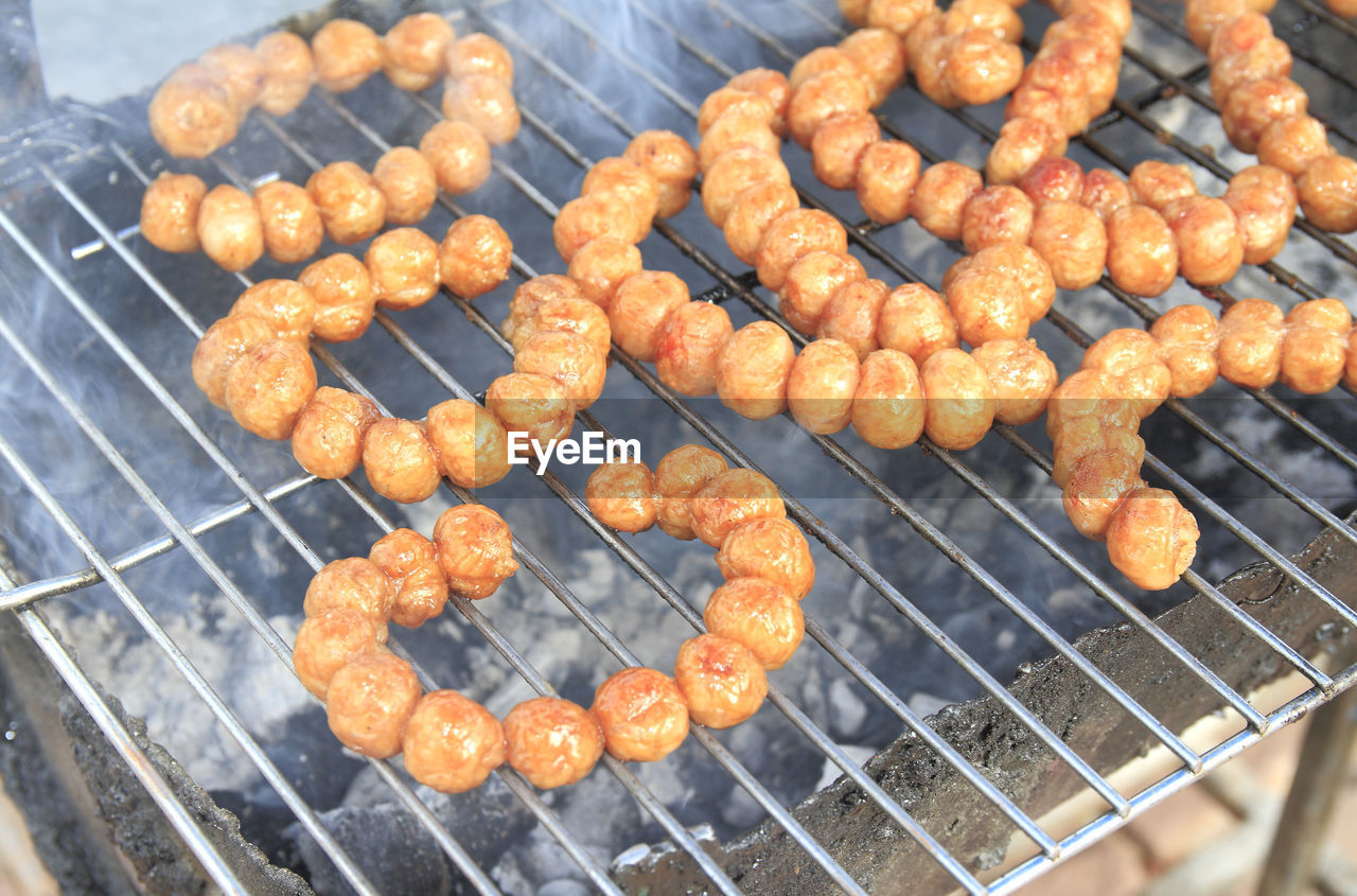 CLOSE-UP OF ROASTED MEAT ON BARBECUE