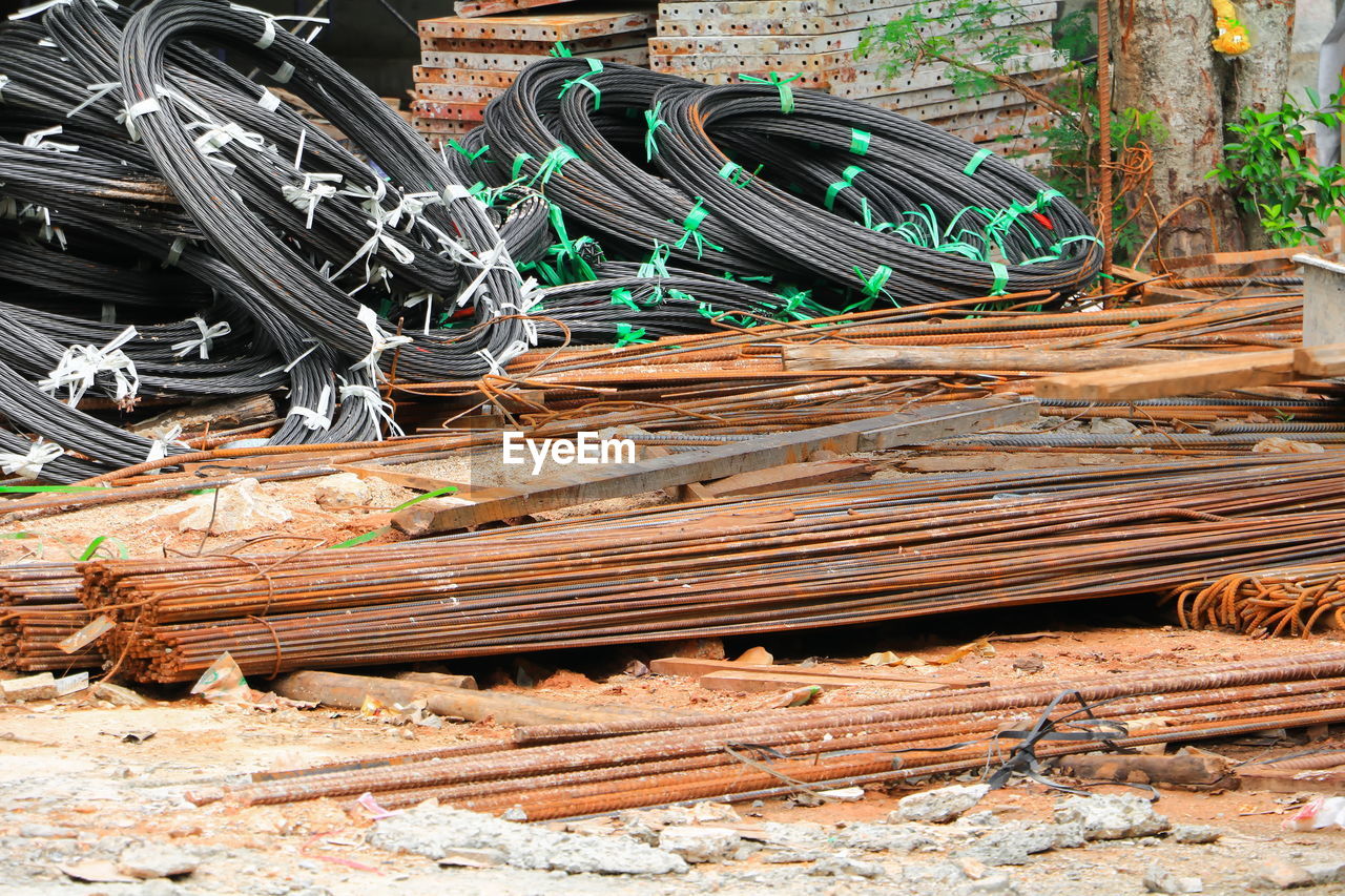 HIGH ANGLE VIEW OF RUSTY METAL BY FENCE ON FIELD