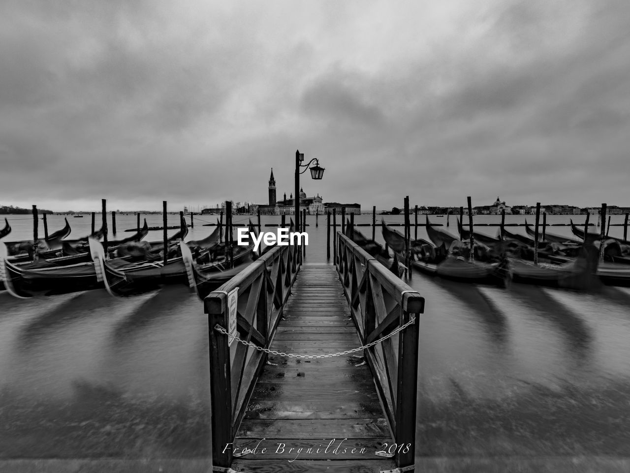 WOODEN PIER OVER SEA AGAINST CLOUDY SKY