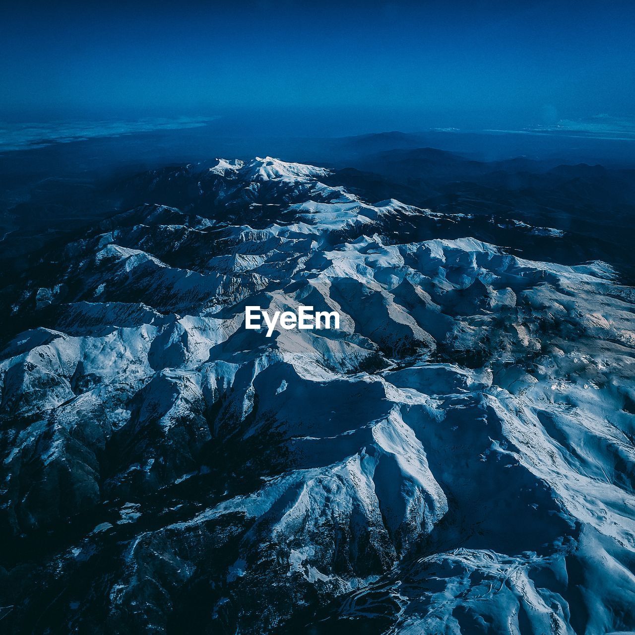 Aerial view of snowcapped mountains against sky