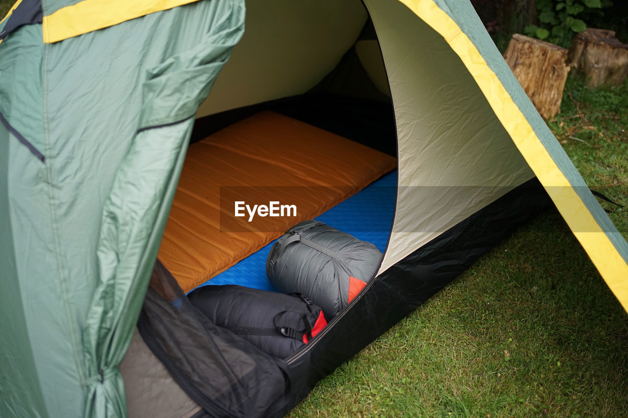 Close up look into a camping tent with sleeping bags and self inflatable sleeping pads