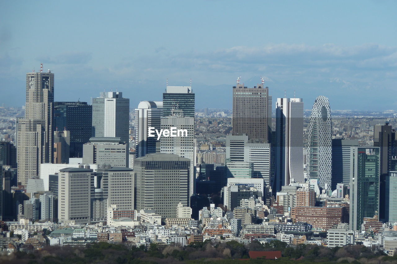 Modern buildings in city against sky in tokyo