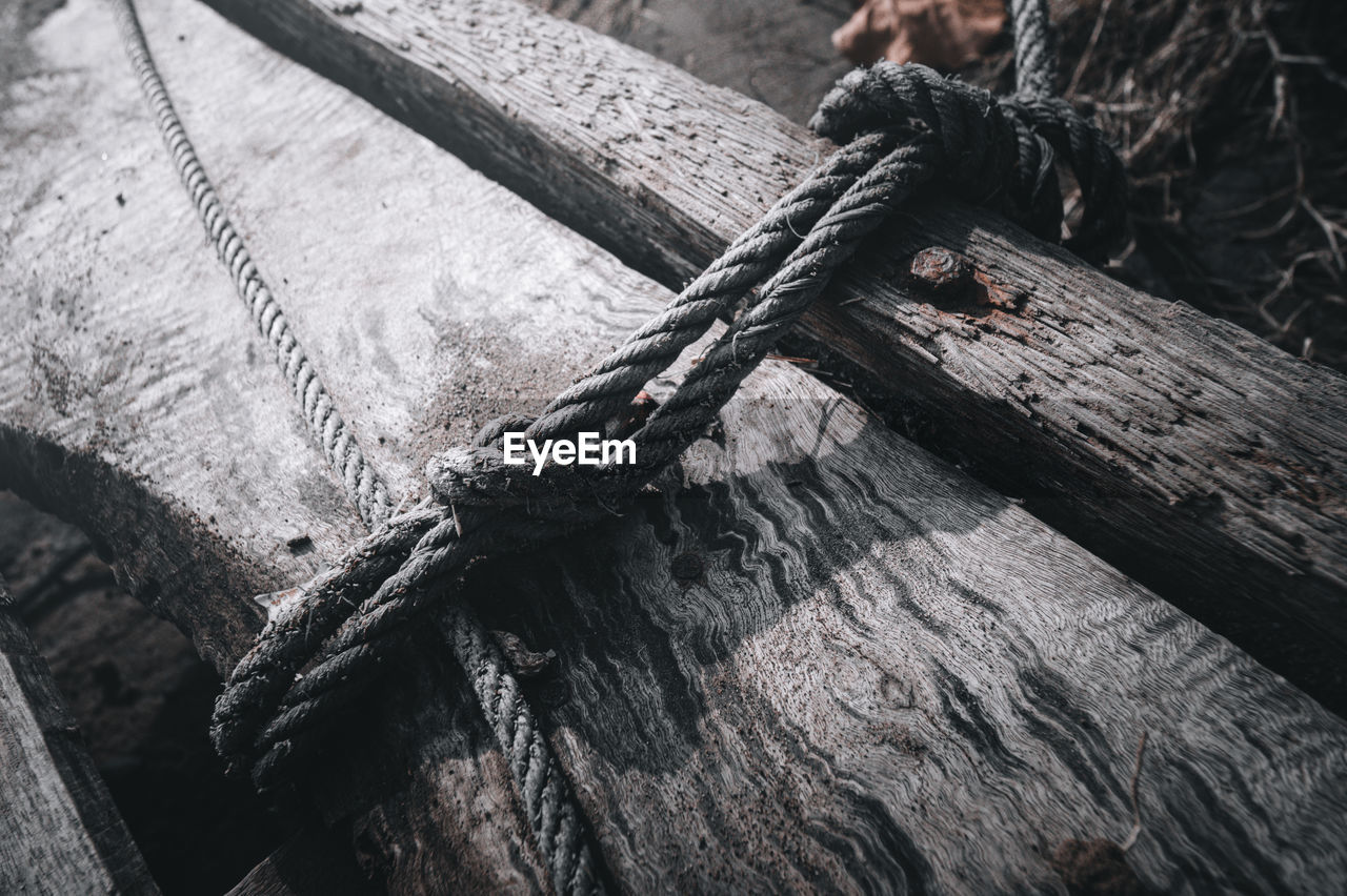 High angle view of rope tied up on wood