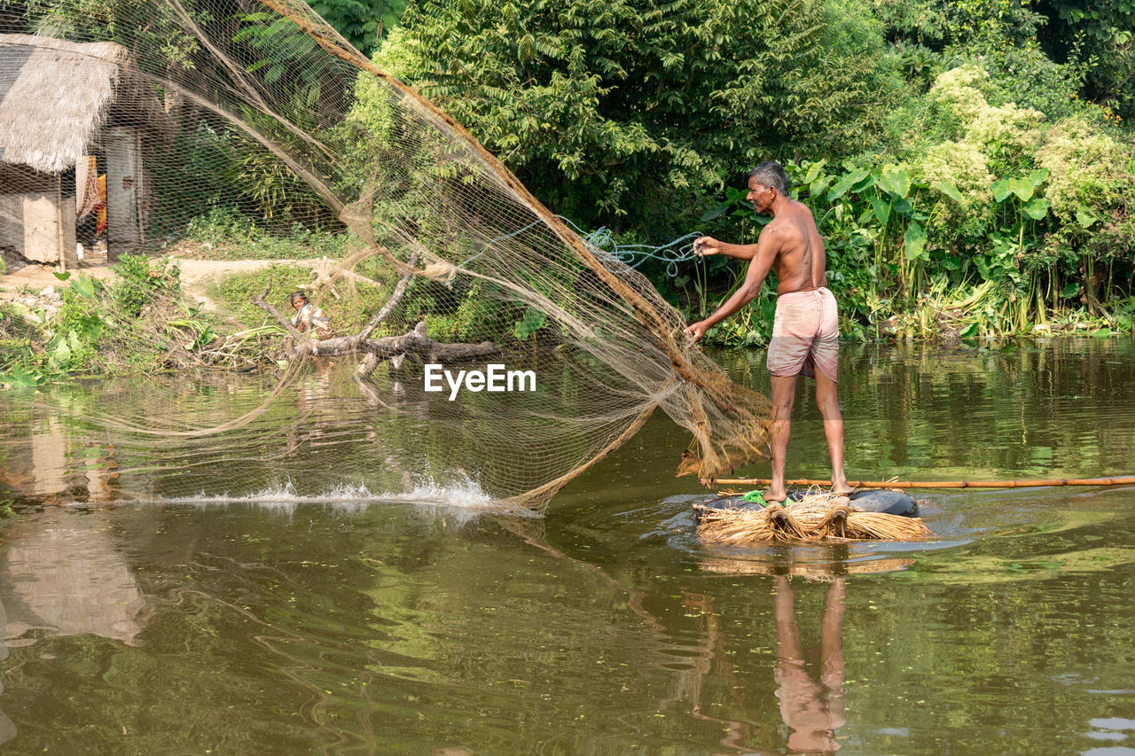 MAN FISHING IN LAKE