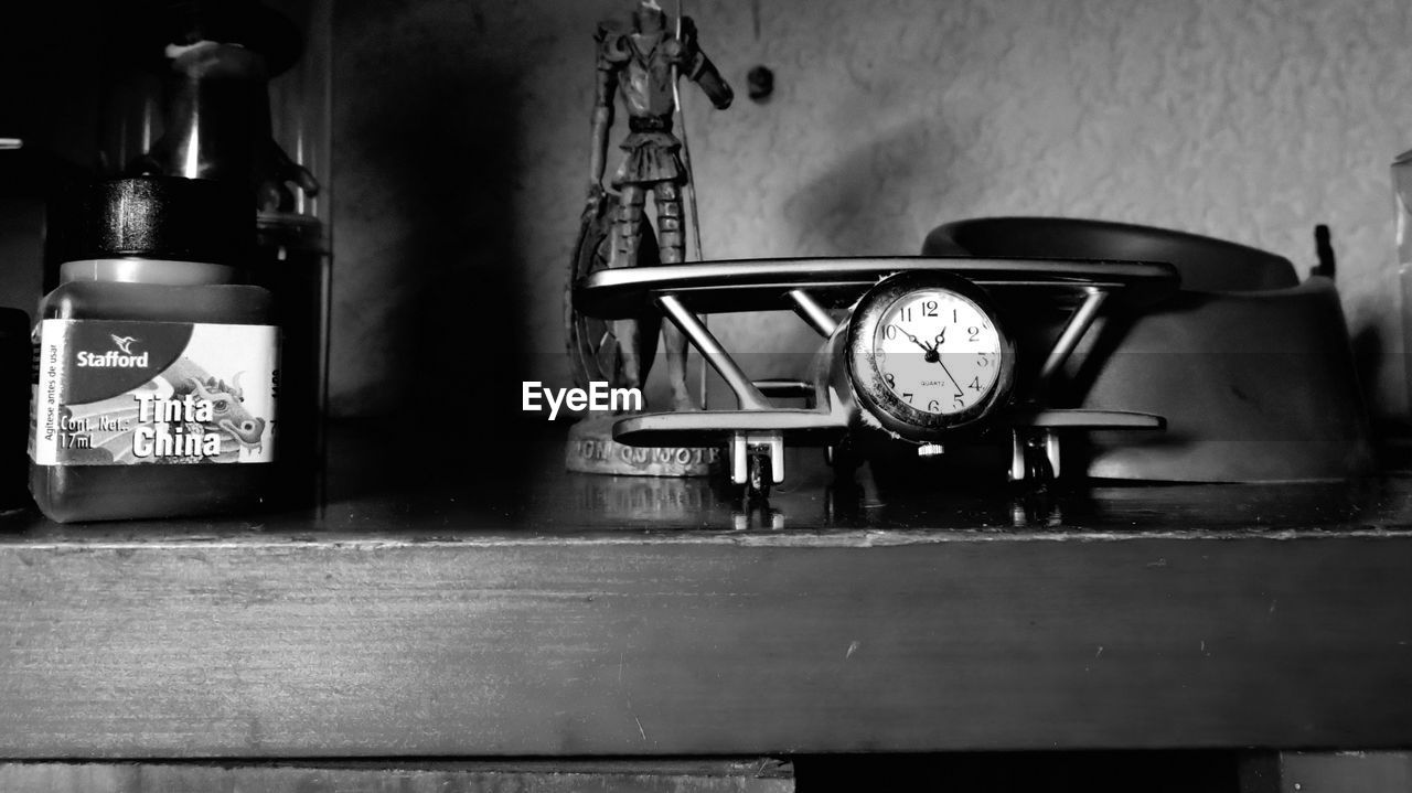 CLOSE-UP OF CLOCK ON FLOOR