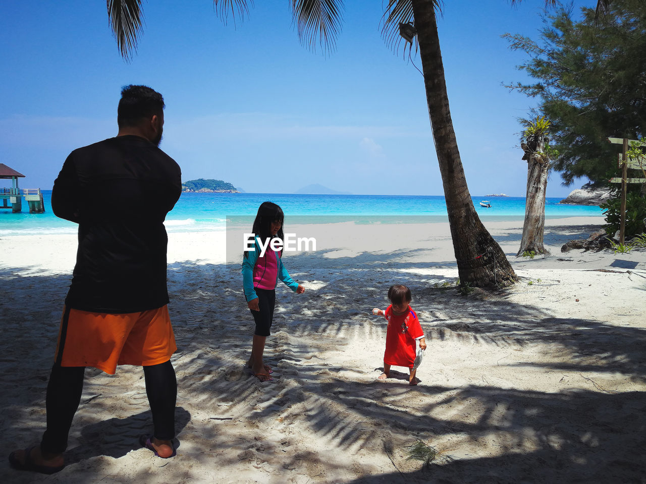 People at beach against sky