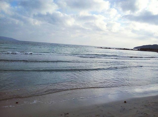 VIEW OF BEACH AGAINST CLOUDY SKY