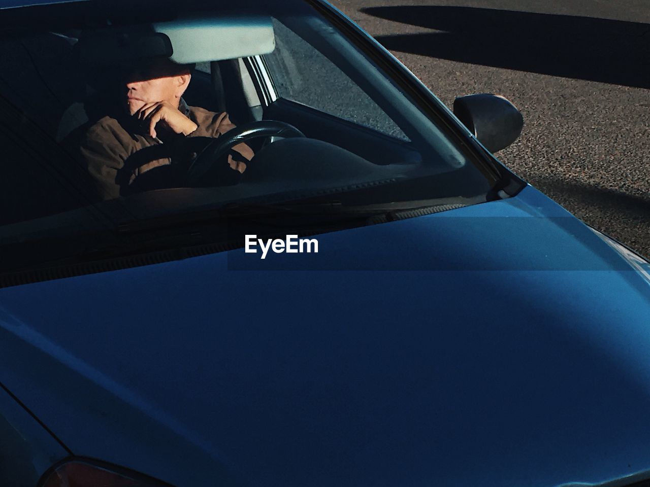 WOMAN SITTING IN CAR WINDOW