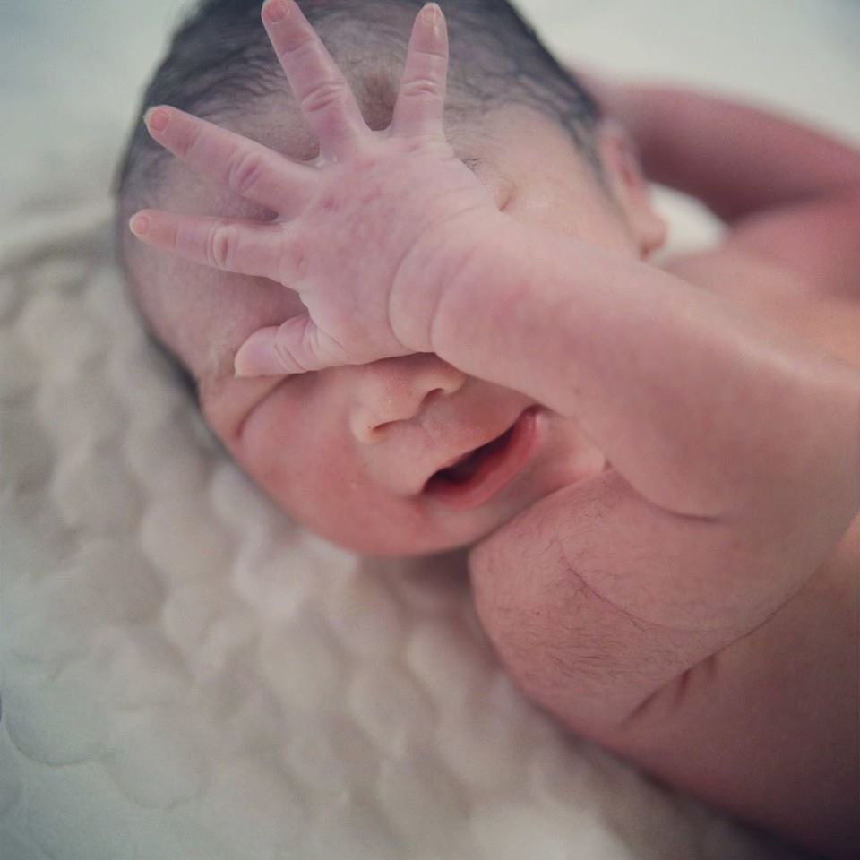 CLOSE-UP OF HANDS HOLDING BABY