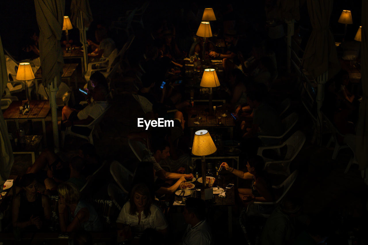 High angle view of people at illuminated restaurant