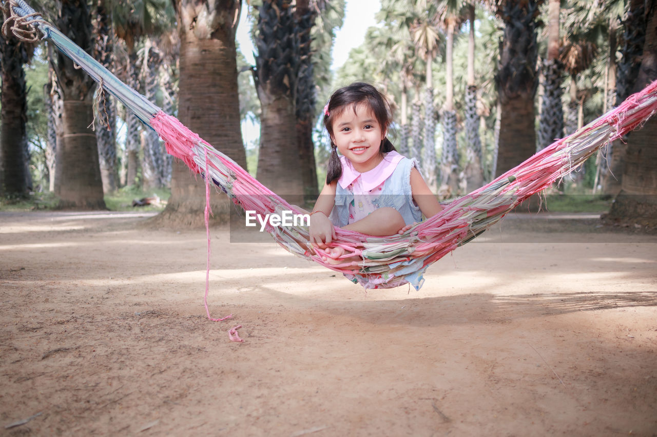 Portrait of girl sitting on hammock