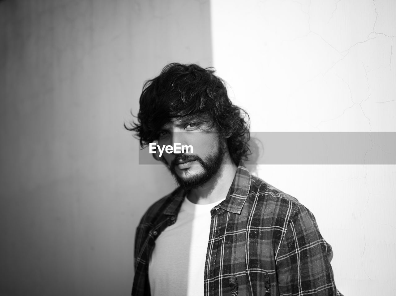 Portrait of man standing against wall