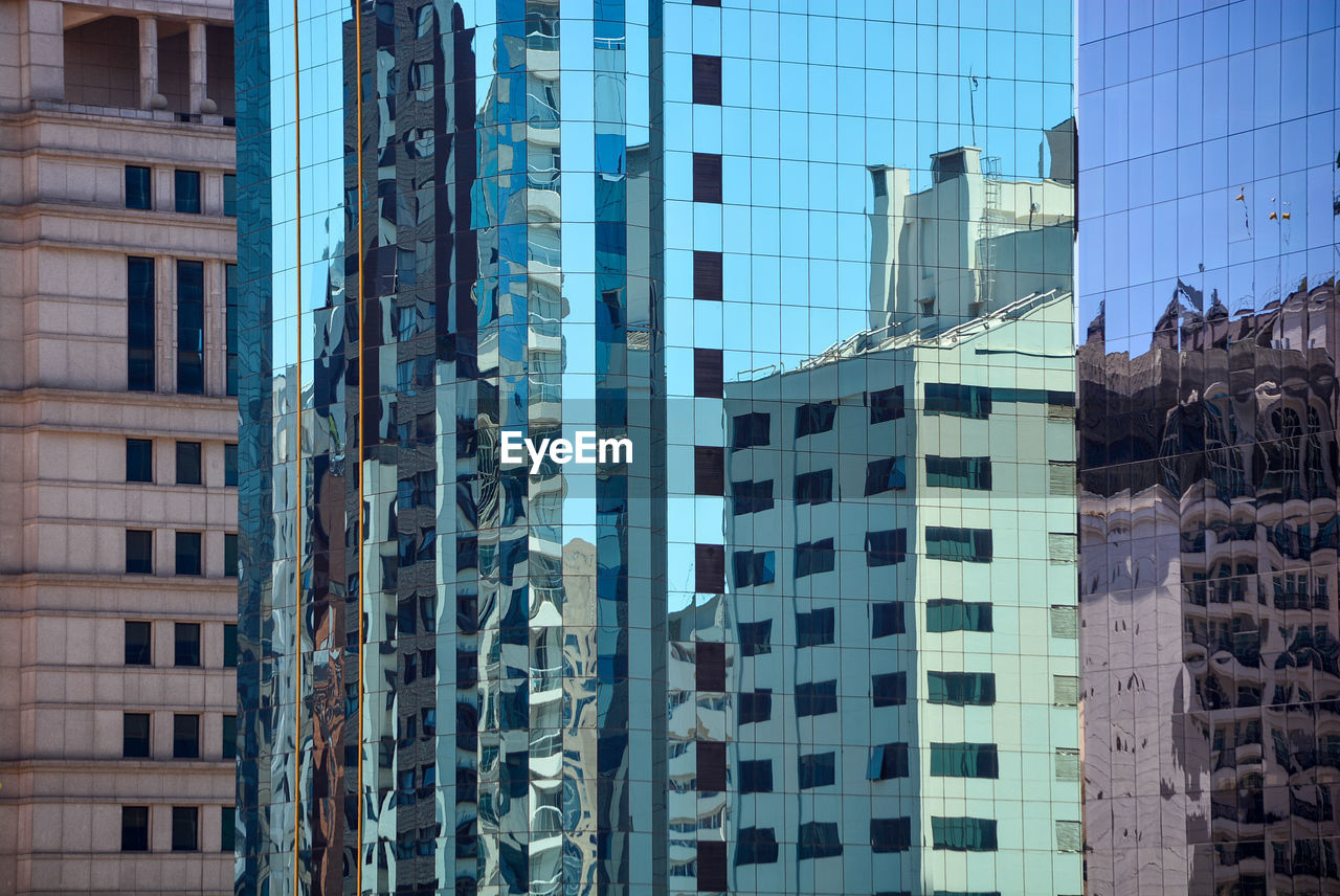 Low angle view of modern glass building in city