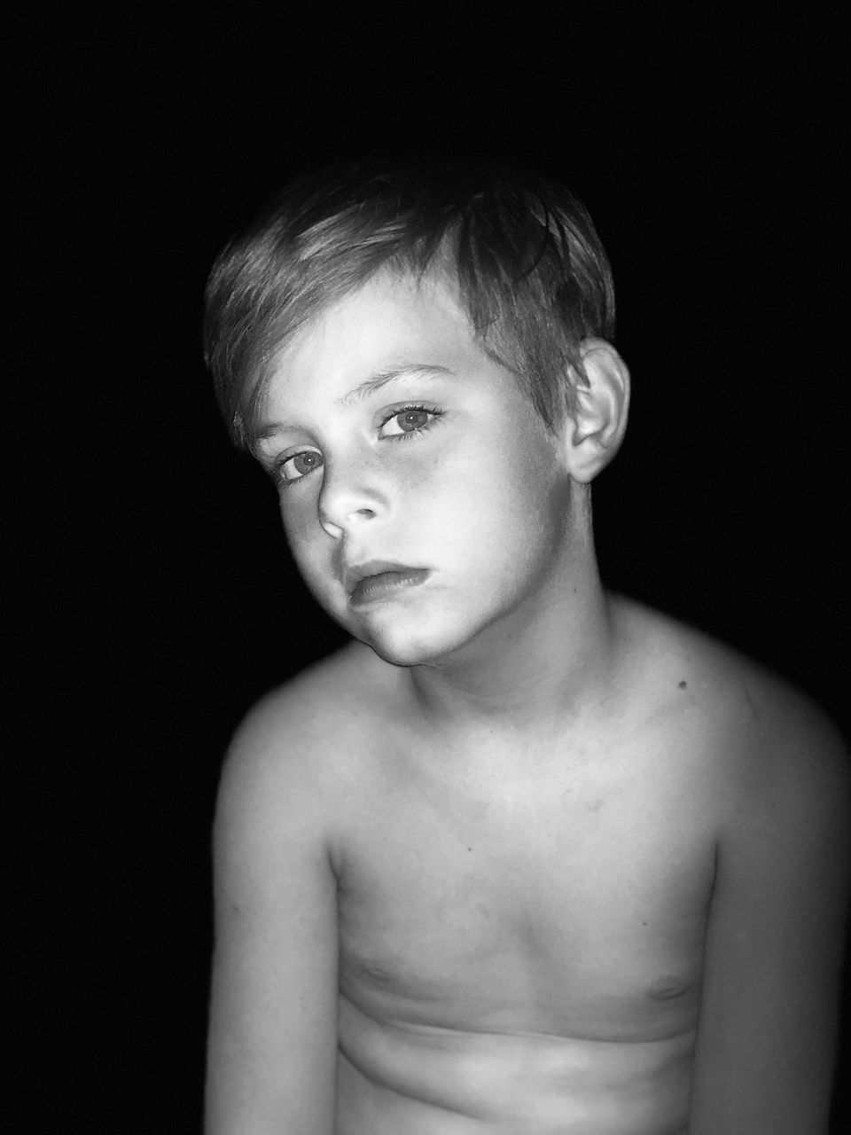 PORTRAIT OF SHIRTLESS BOY AGAINST GRAY BACKGROUND