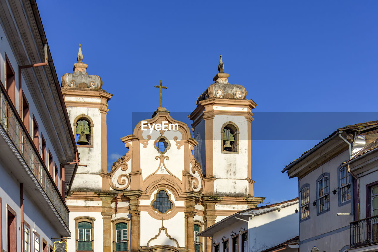 Facade of historic colonial style house and church in the famous city of ouro preto