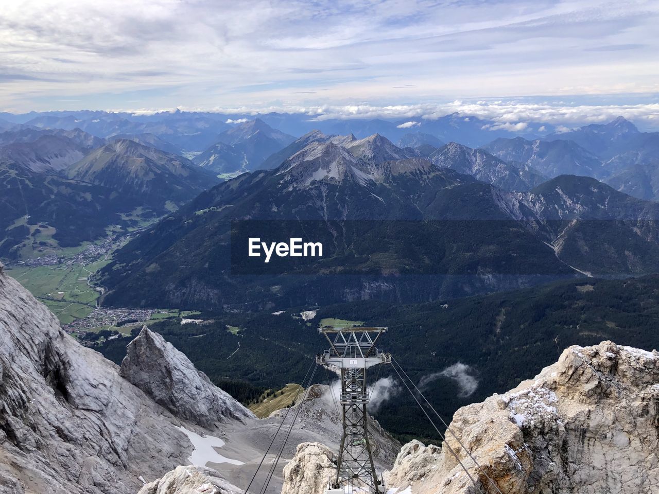 Scenic view of mountain range against cloudy sky