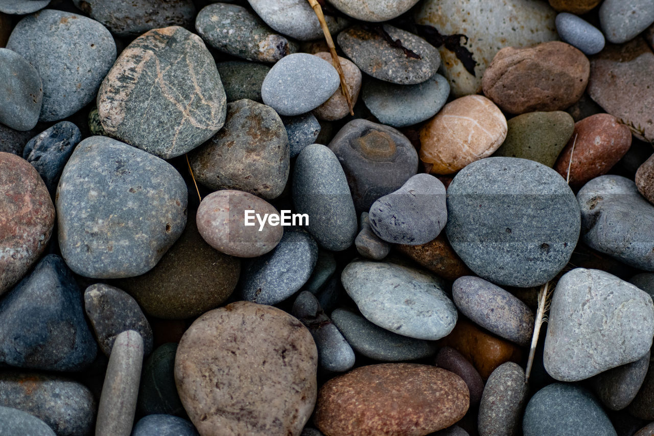 pebble, rock, large group of objects, backgrounds, full frame, gravel, stone, abundance, soil, no people, nature, shape, textured, variation, close-up, land, high angle view, beach, directly above, outdoors, pattern, gray, day