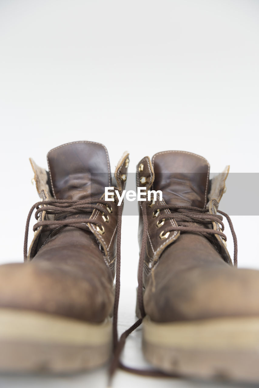 Close-up of boots against white background