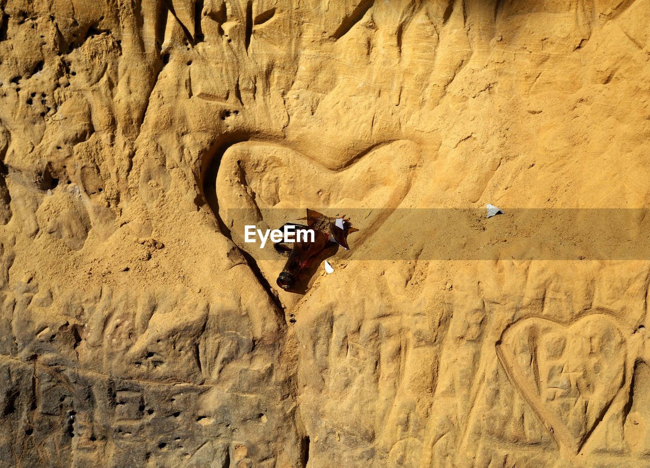 HIGH ANGLE VIEW OF PEOPLE ON ROCK FORMATIONS